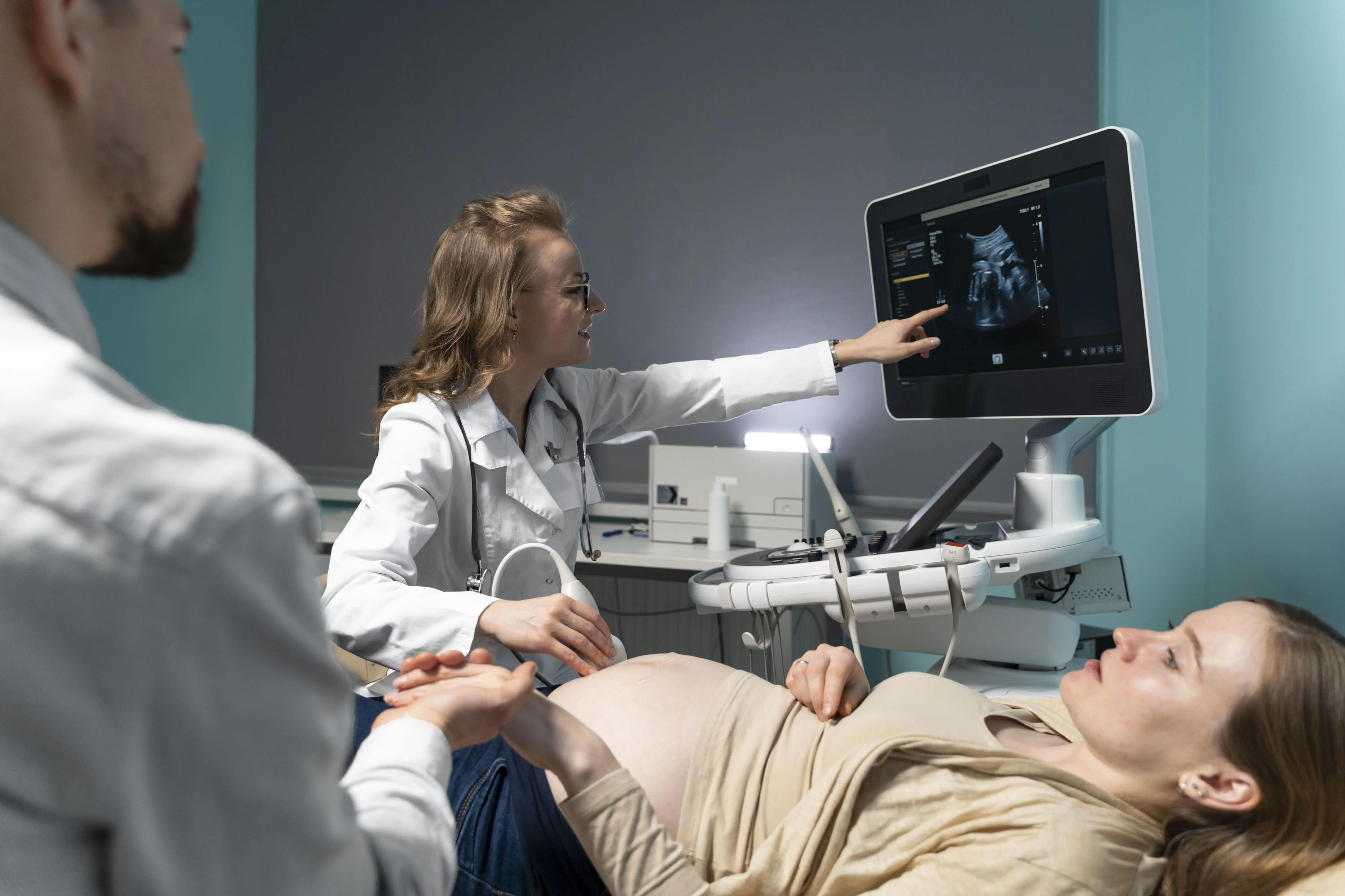 Doctor performing pregnancy ultrasound and explaining results to expecting parents, supported through international maternity treatment coordination by 360Five Medicare